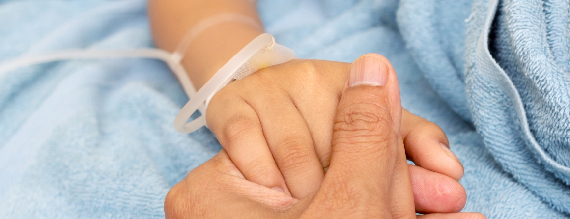 A child holding and adult's hand
